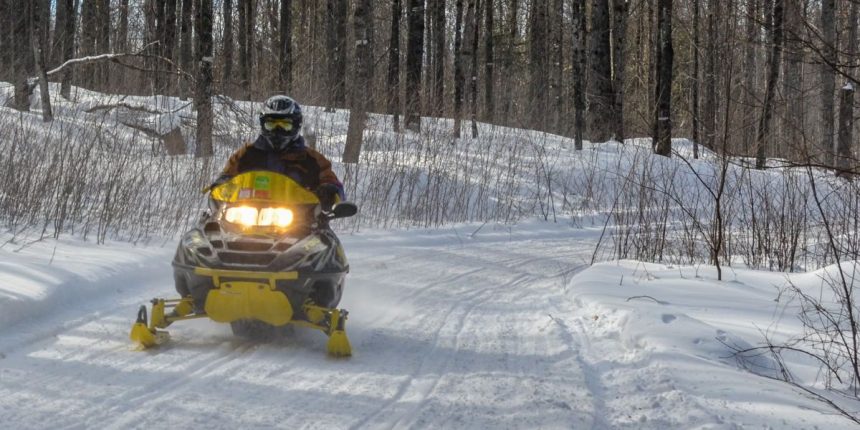 Illinois Man Dies After Snowmobile Collides With Powerline Structure in Northern Michigan, Woman Seriously Injured