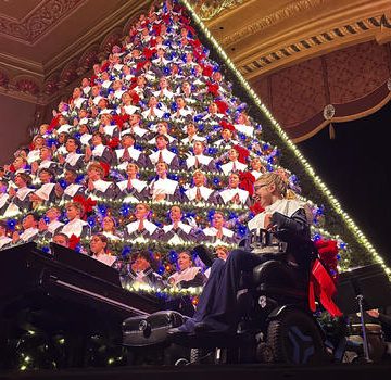 Michigan high school choir performs holiday tunes from a towering Christmas tree